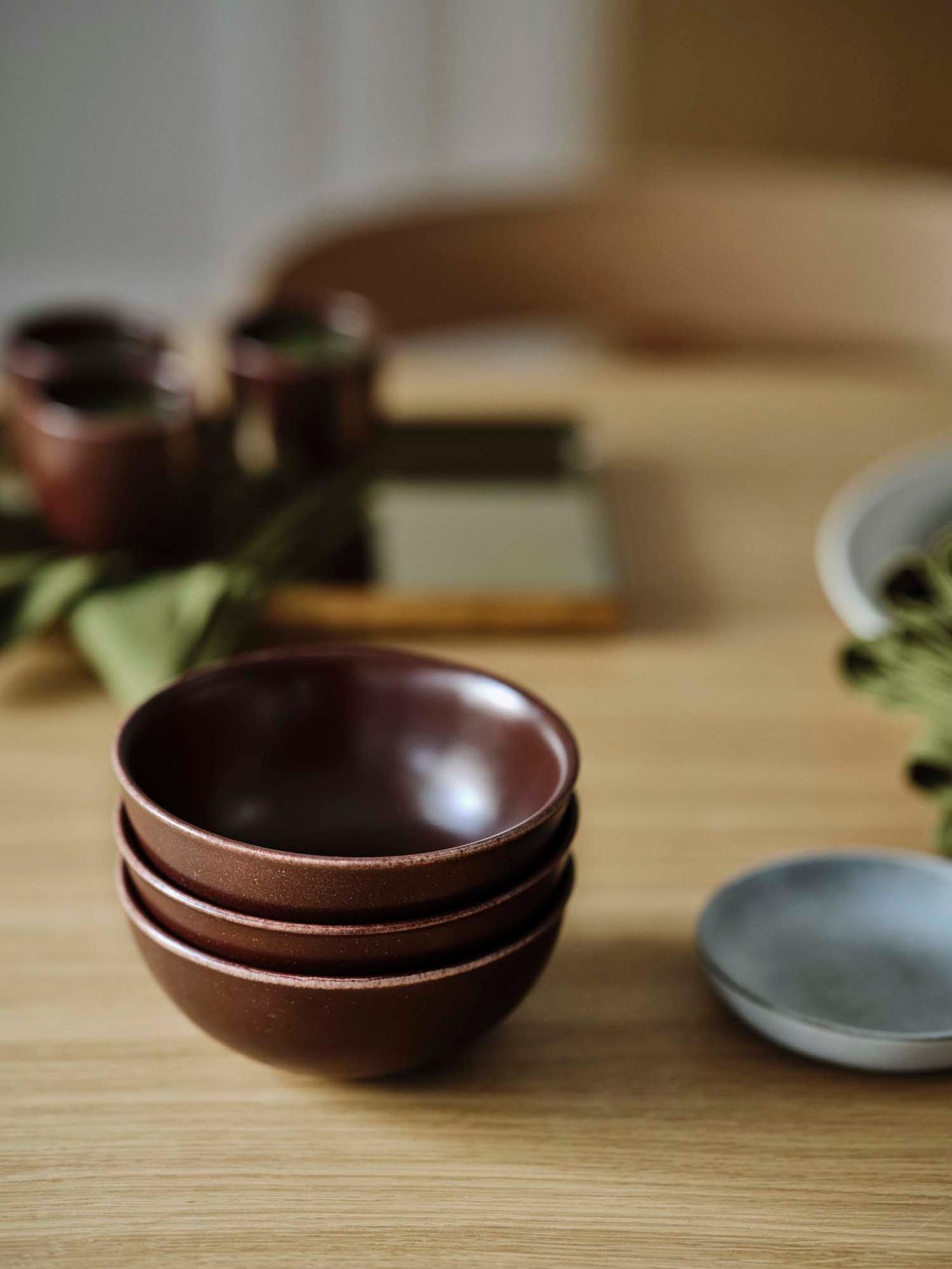 A stack of three brown STOCKHOLM 2025 bowls.