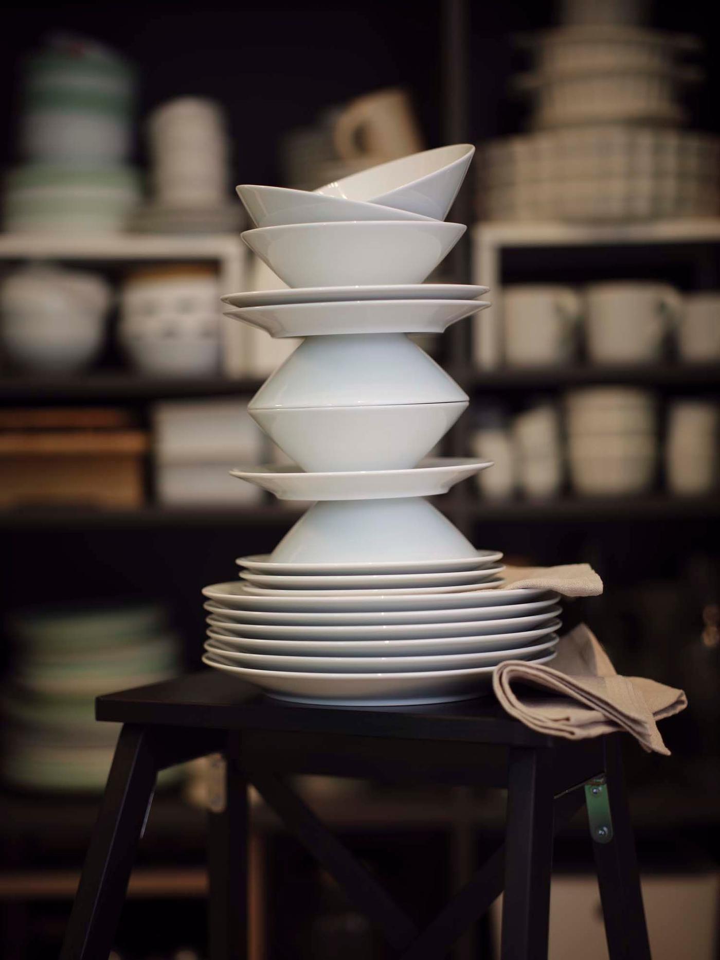 A playful tower of stacked white IKEA 365+ dinnerware.