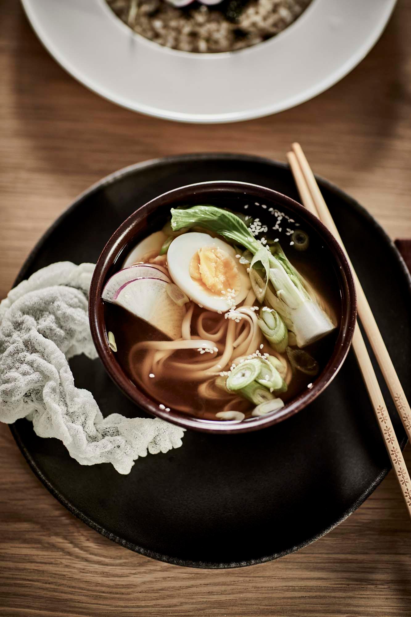 Ramen served in a rustic brown STOCKHOLM 2025 bowl.