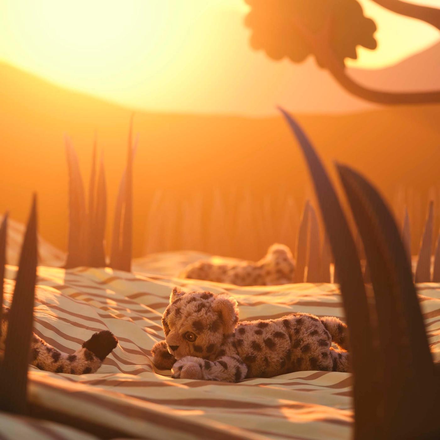 A soft toy cheetah cub following its mother's tail in an imaginary African savannah setting with long grass.