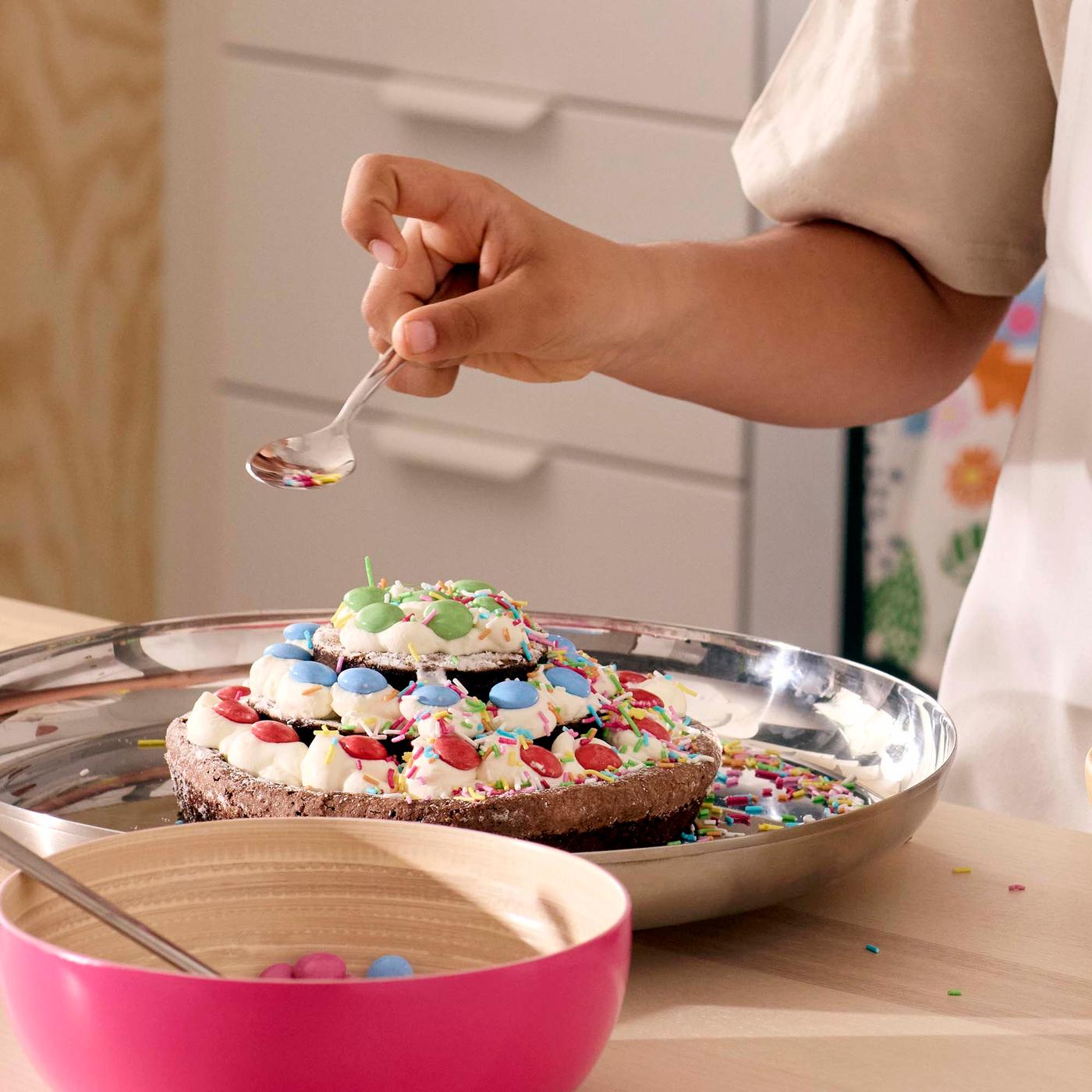 A close up of a child decorating a cake.