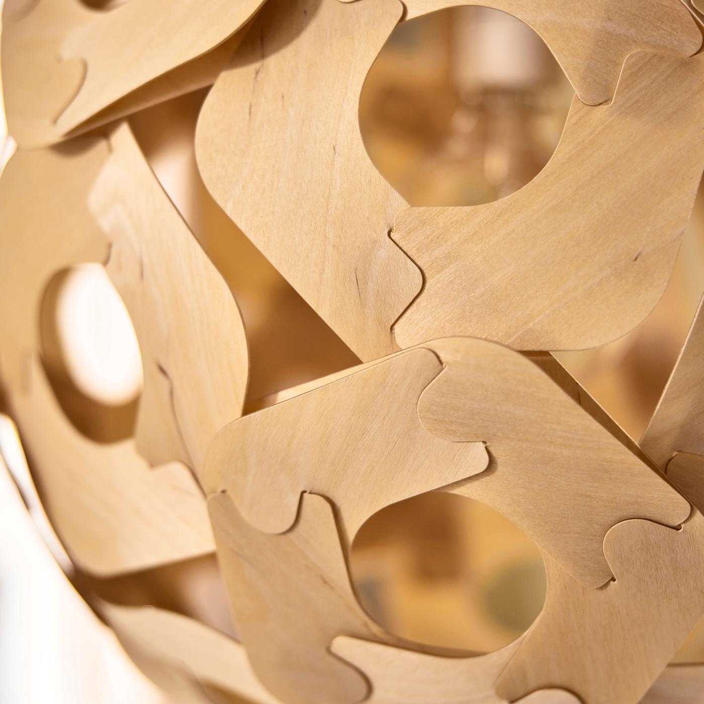 Close-up of a wooden-look pendant lamp, showing interlocking parts and detailed texture with a natural wood expression.