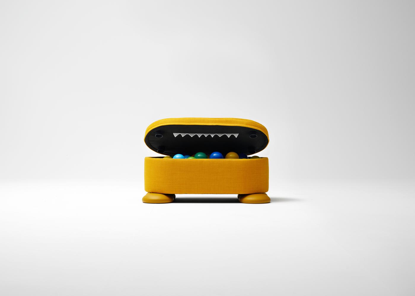 A yellow round storage box with its lid open, revealing a hidden design detail resembling teeth, placed on a white background.