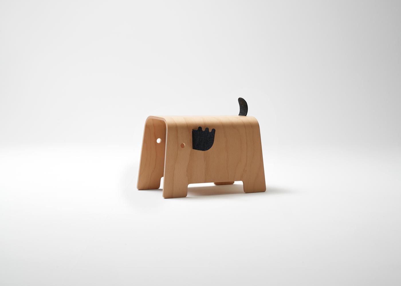 A moose shaped wooden stool with on a white background.