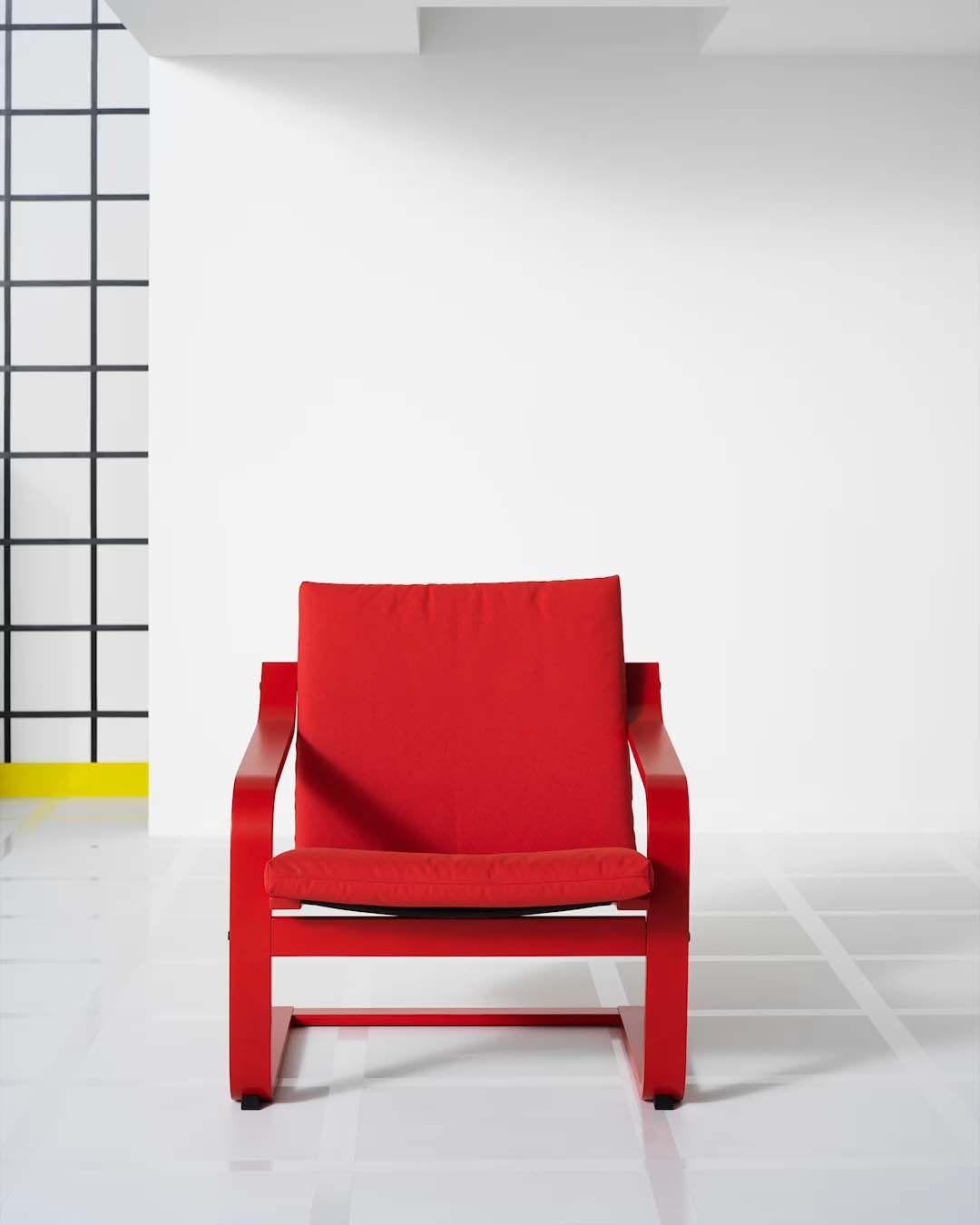 A red POÄNG armchair against a white backdrop.