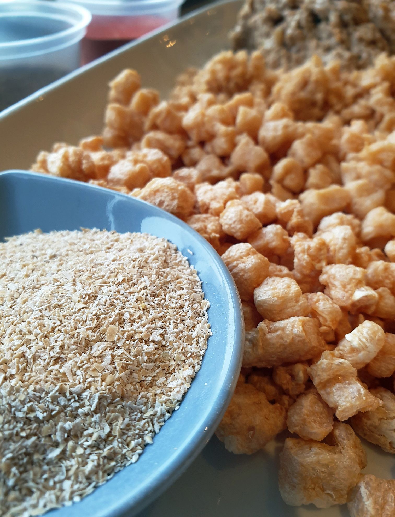 A plate and a tray with different food ingredients.