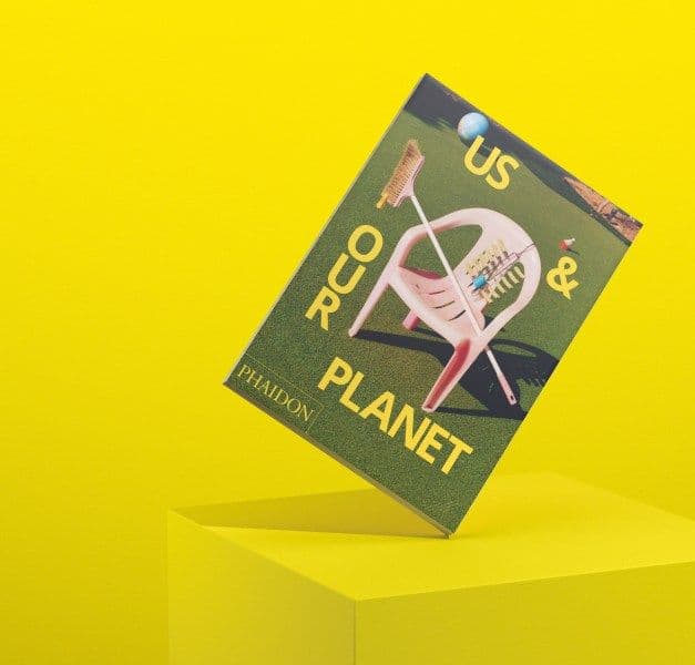 A book with the words Us & Our Planet on the cover.