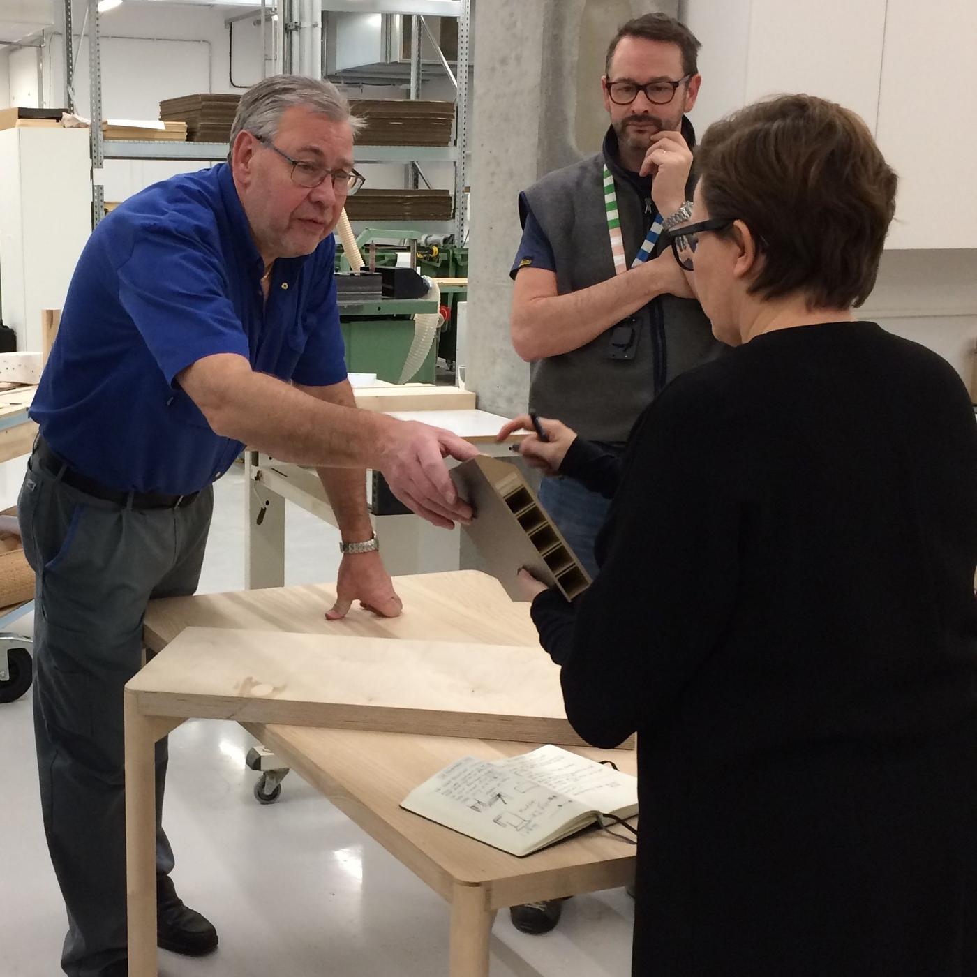 A group of people examining RÅVAROR prototypes.