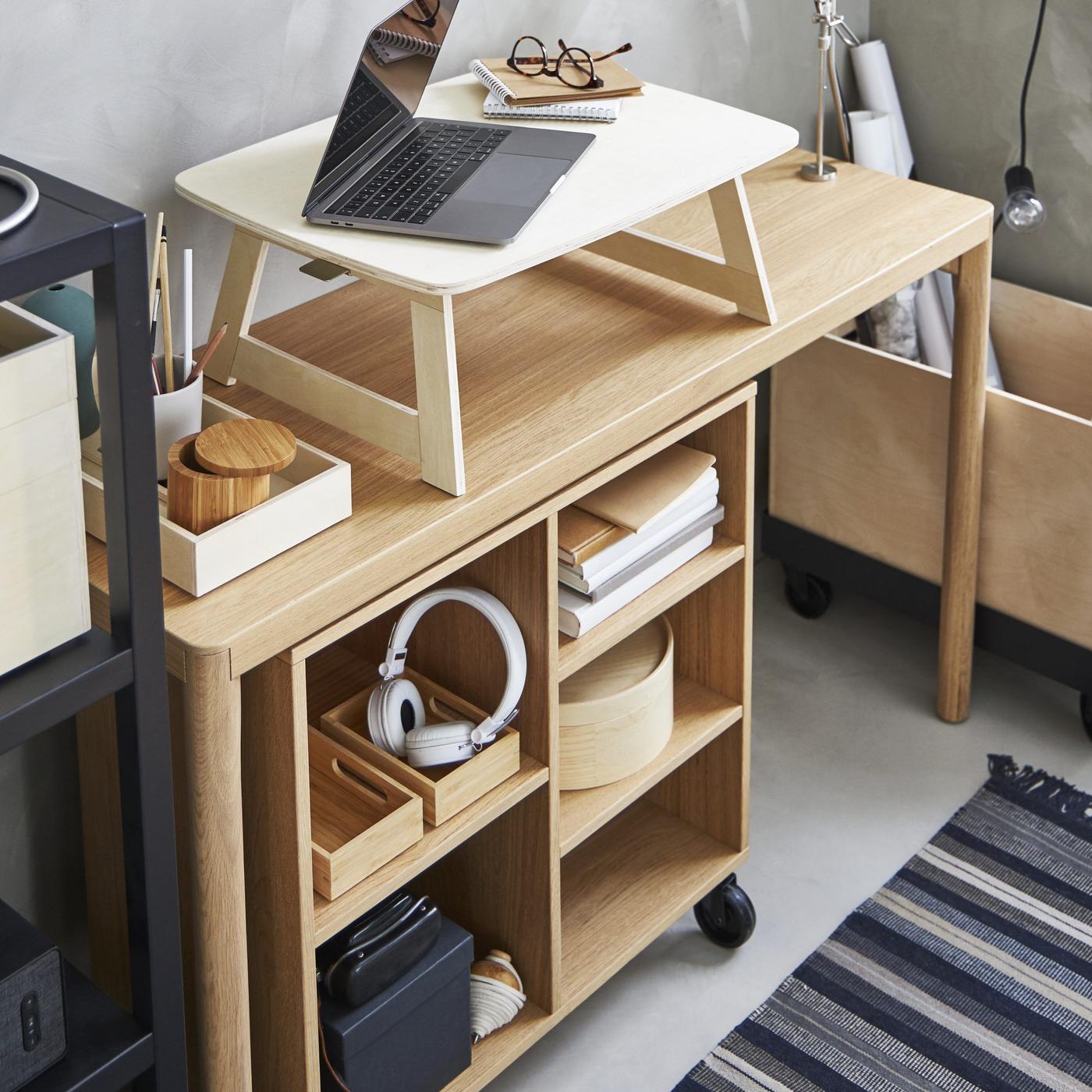 A RÅVAROR table, storage and box on castors and a tray with a computer and glasses.