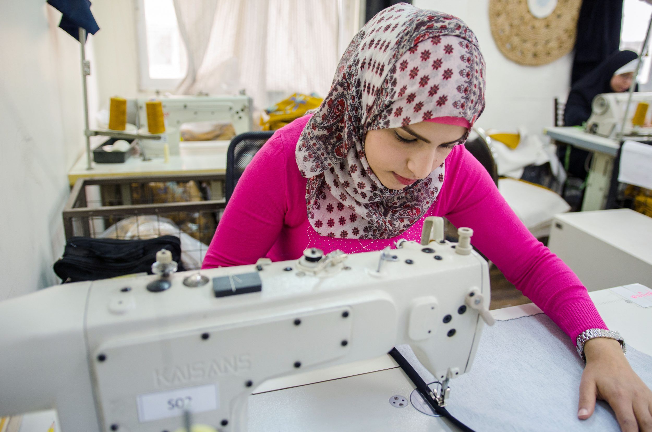 A woman using a sewing machine.