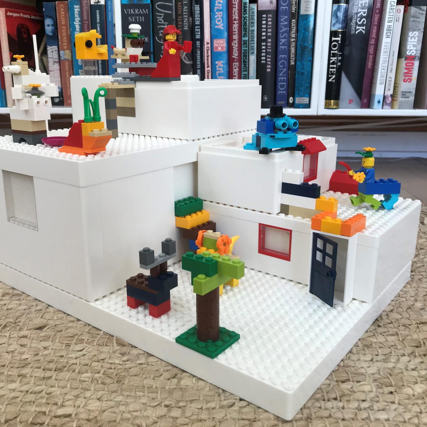 A multicoloured landscape built with BYGGLEK LEGO boxes and brick set on a floor.