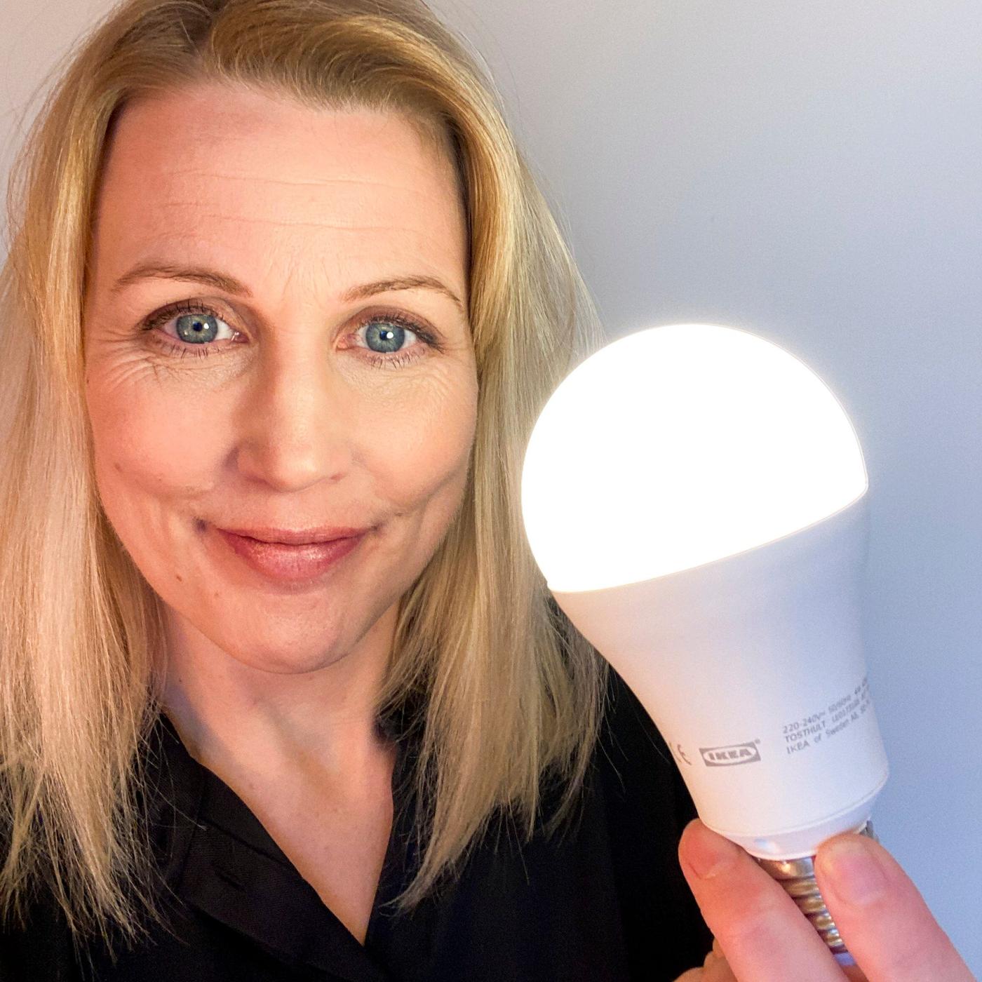 A woman with a lightbulb in her hand.