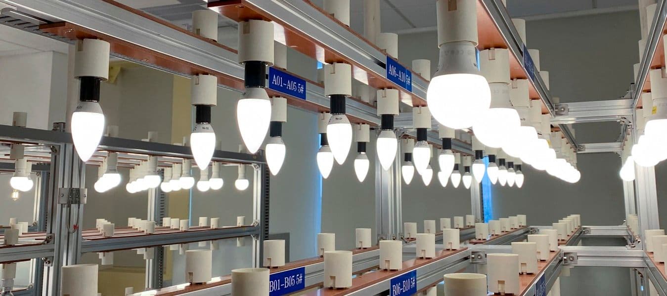 A test lab with a row of ceiling mounted light sockets and a row of floor mounted ones. The top row is fitted with LED bulbs.