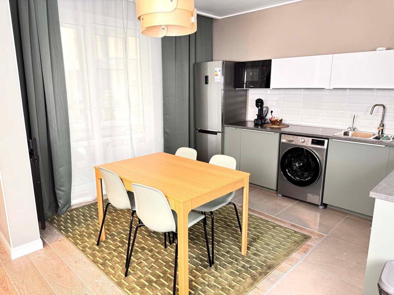 The kitchen and dining area of the Stylish Design Apartments Airbnb in Almaty, Kazakhstan.
