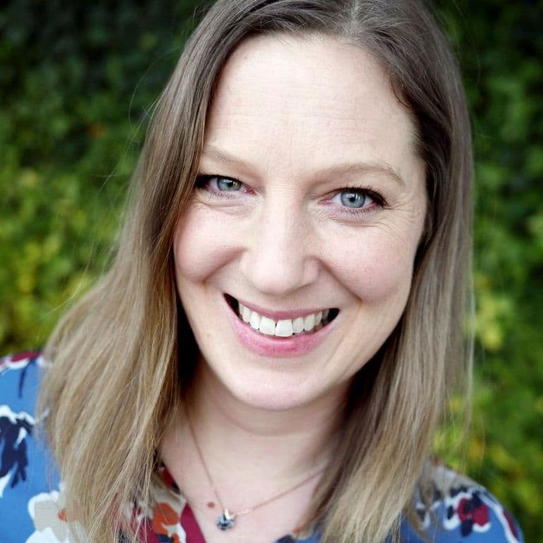 Portrait of Sharla Halvorsen with a green garden backdrop.