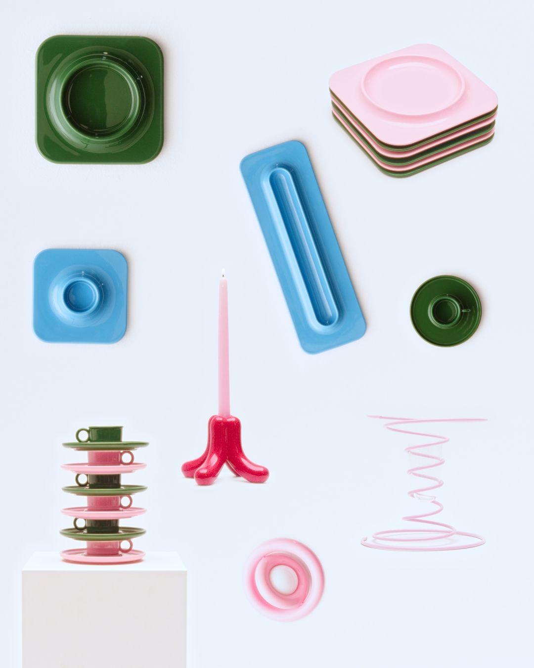 Collection seen from above with stacked and single plates, cups, vases, lamps, and candleholders.