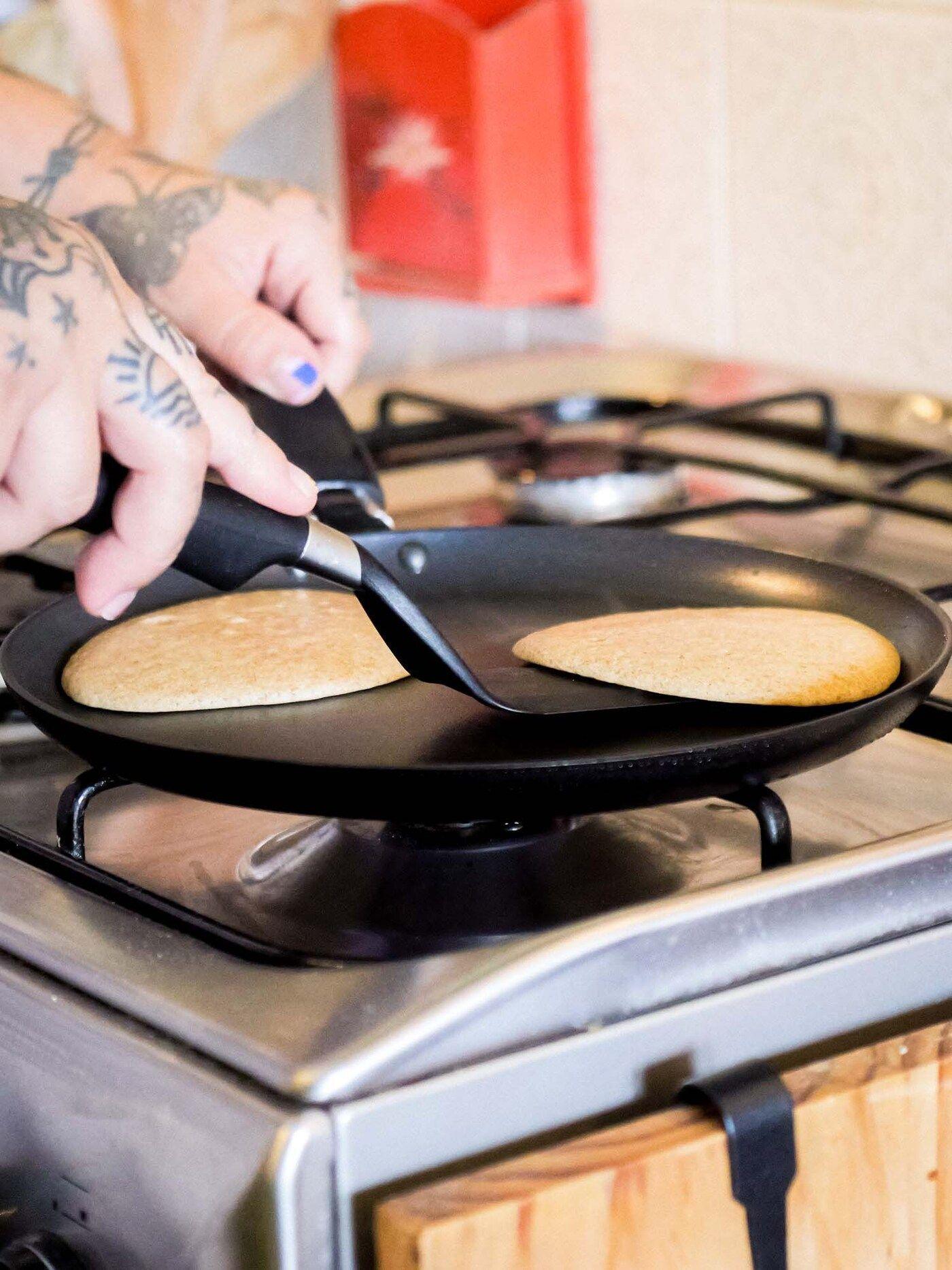 Denise flips pancakes