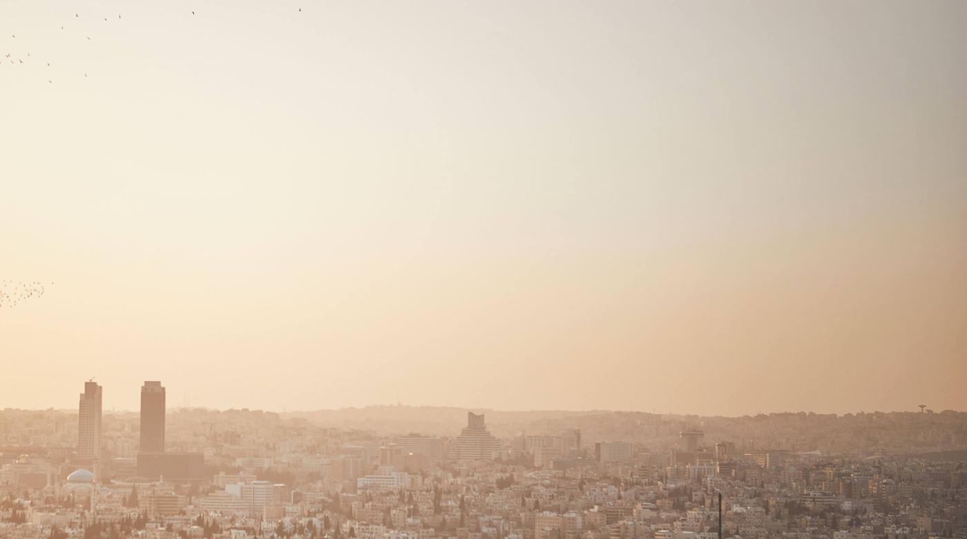 Hazy, afternoon view of a large cityscape.