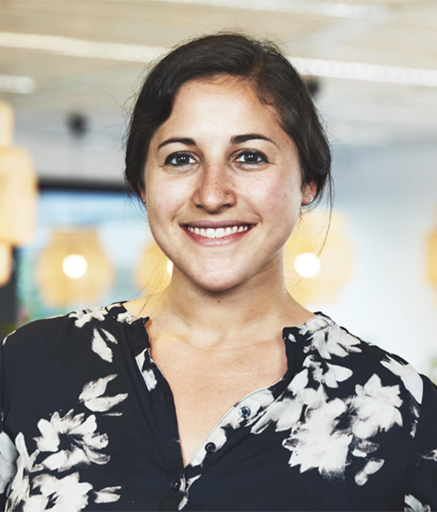 Alexandra Galef, Sustainability Development Leader at IKEA of Sweden, smiles as she stands in a brightly lit office.