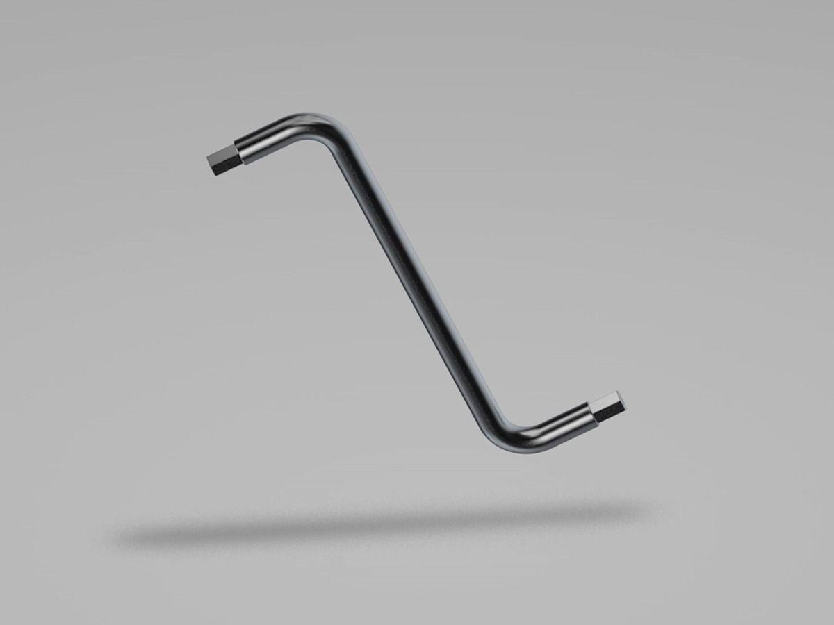 An Allen key is hovering over the ground, over a white background, with its shadow just below.