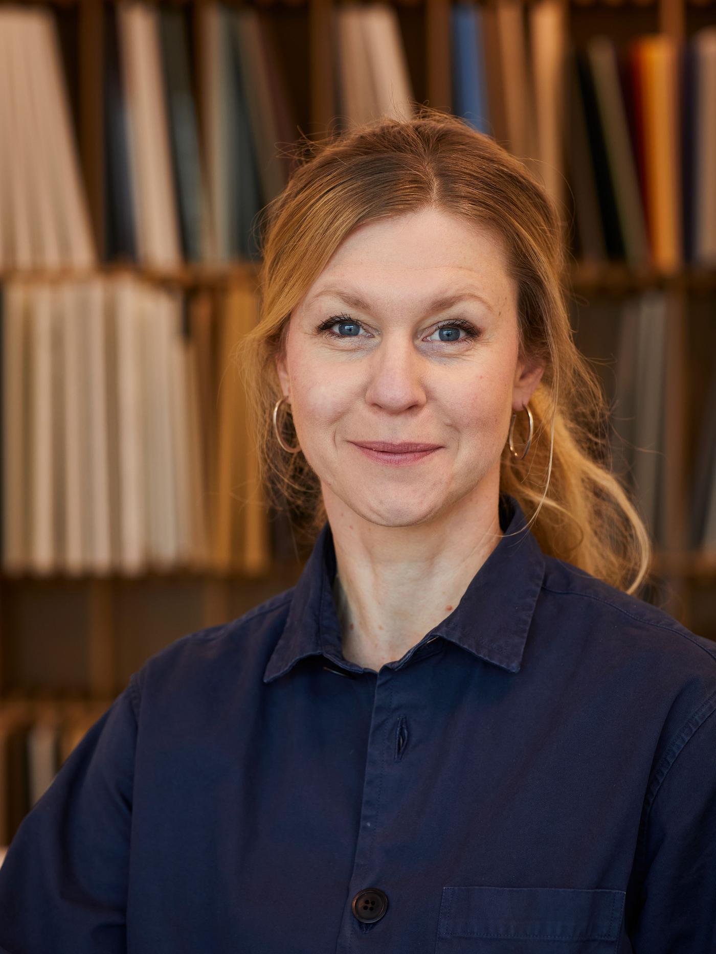 A portrait of Fredrika Inger in a blue shirt