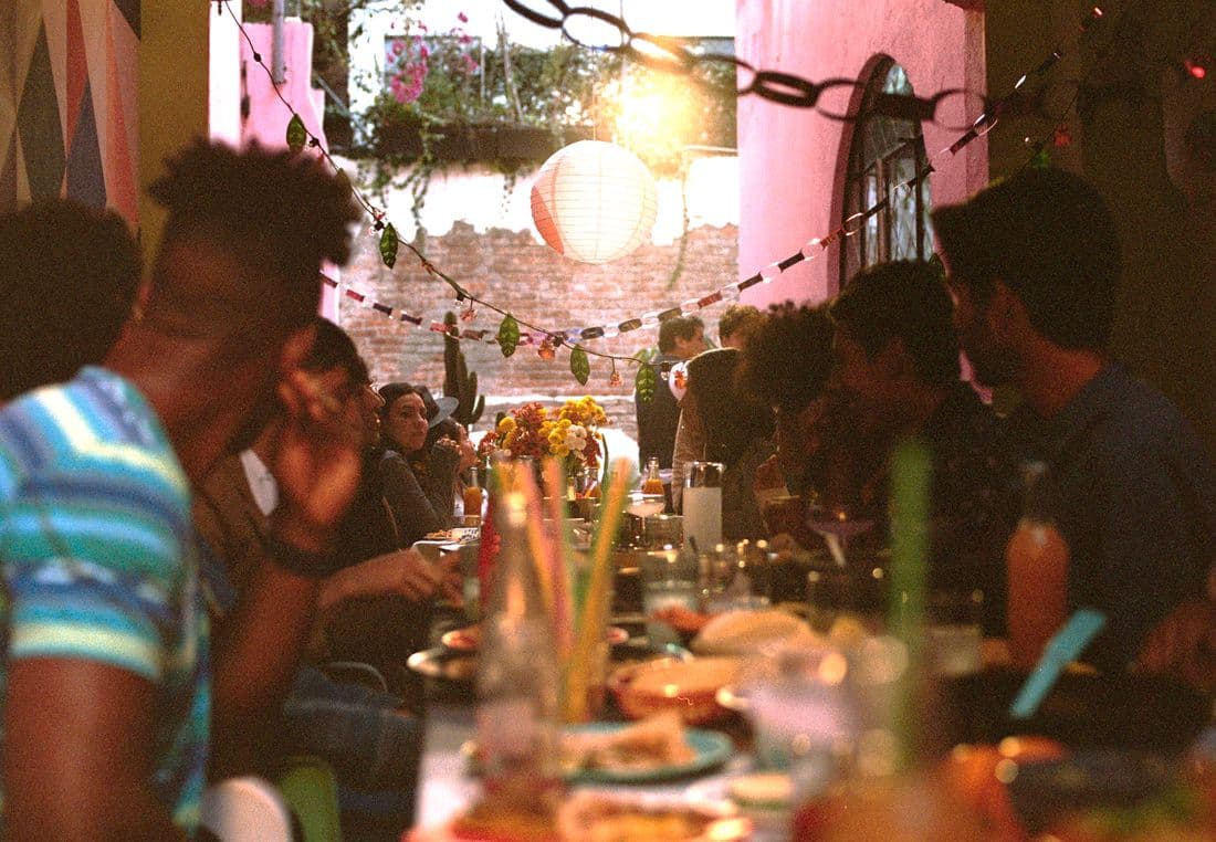 People sitting around a dining table set with festive decorations.