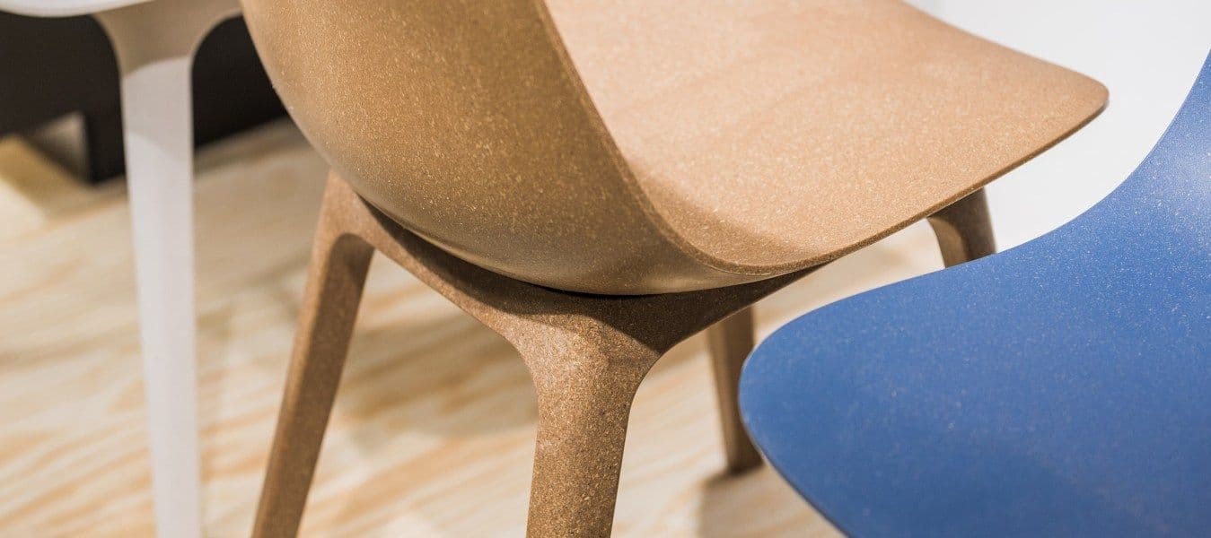 The seats of two chairs, one cork-coloured, the other blue, standing close together.