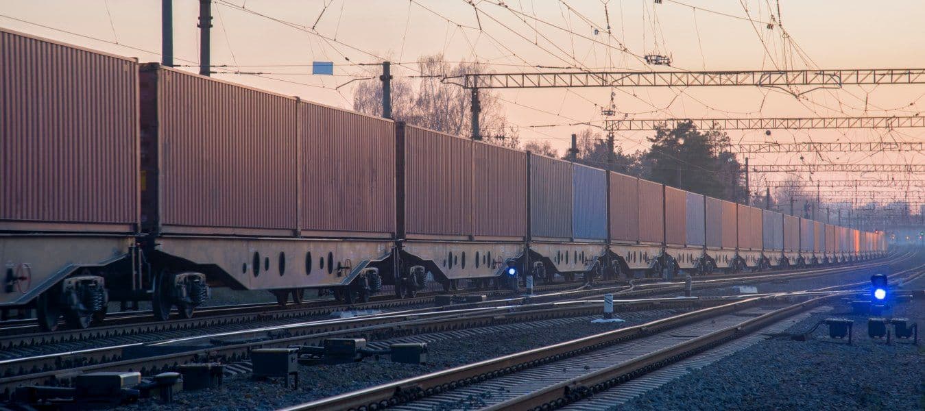 Cargo containers transportation on freight train by railway. 