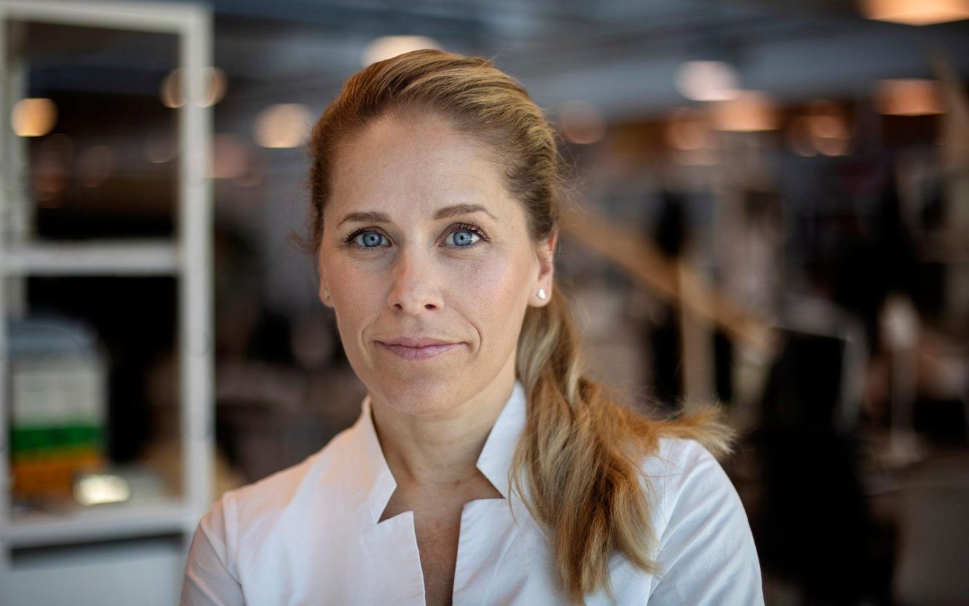 Portrait of a woman in a white shirt.