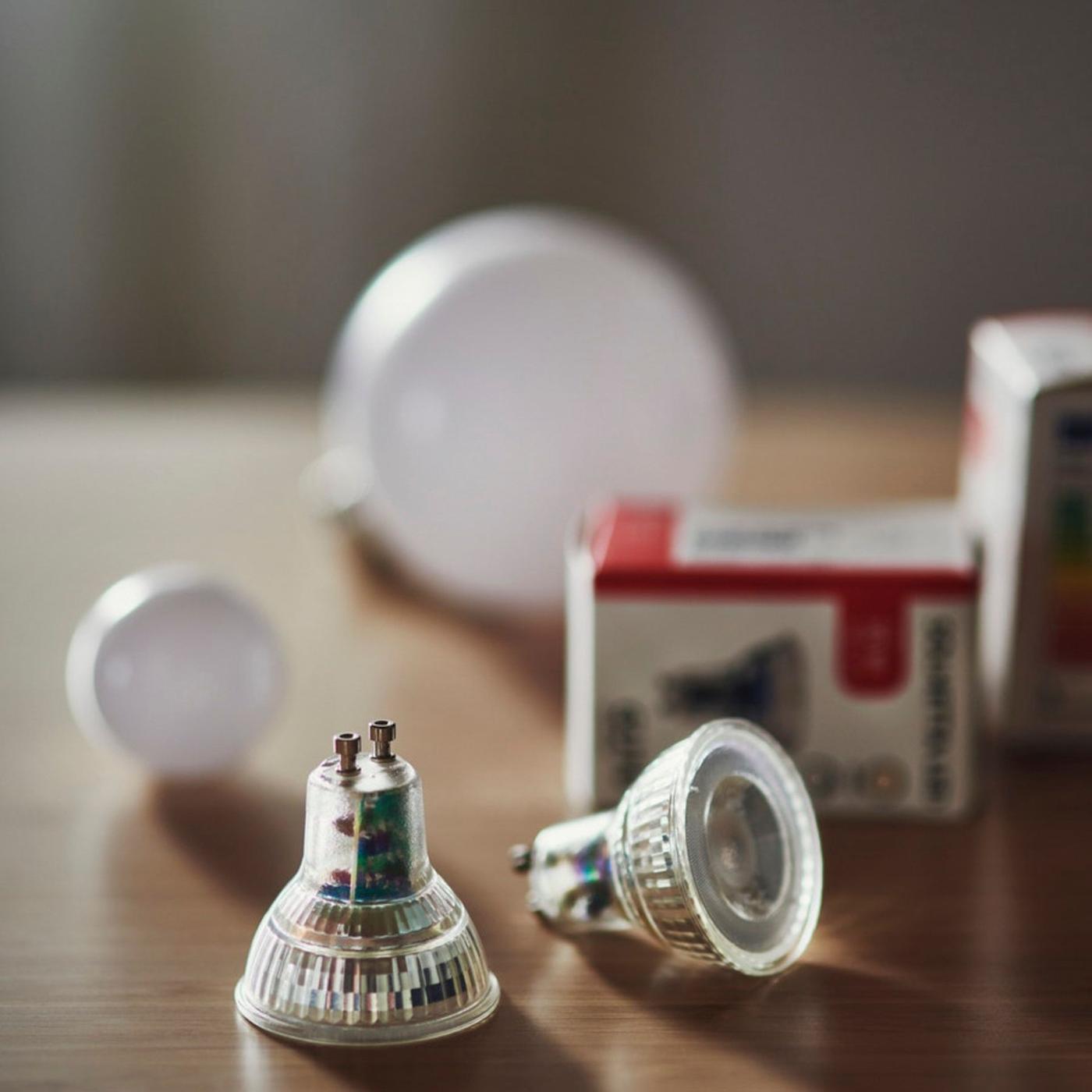 Two lightbulbs on a table.