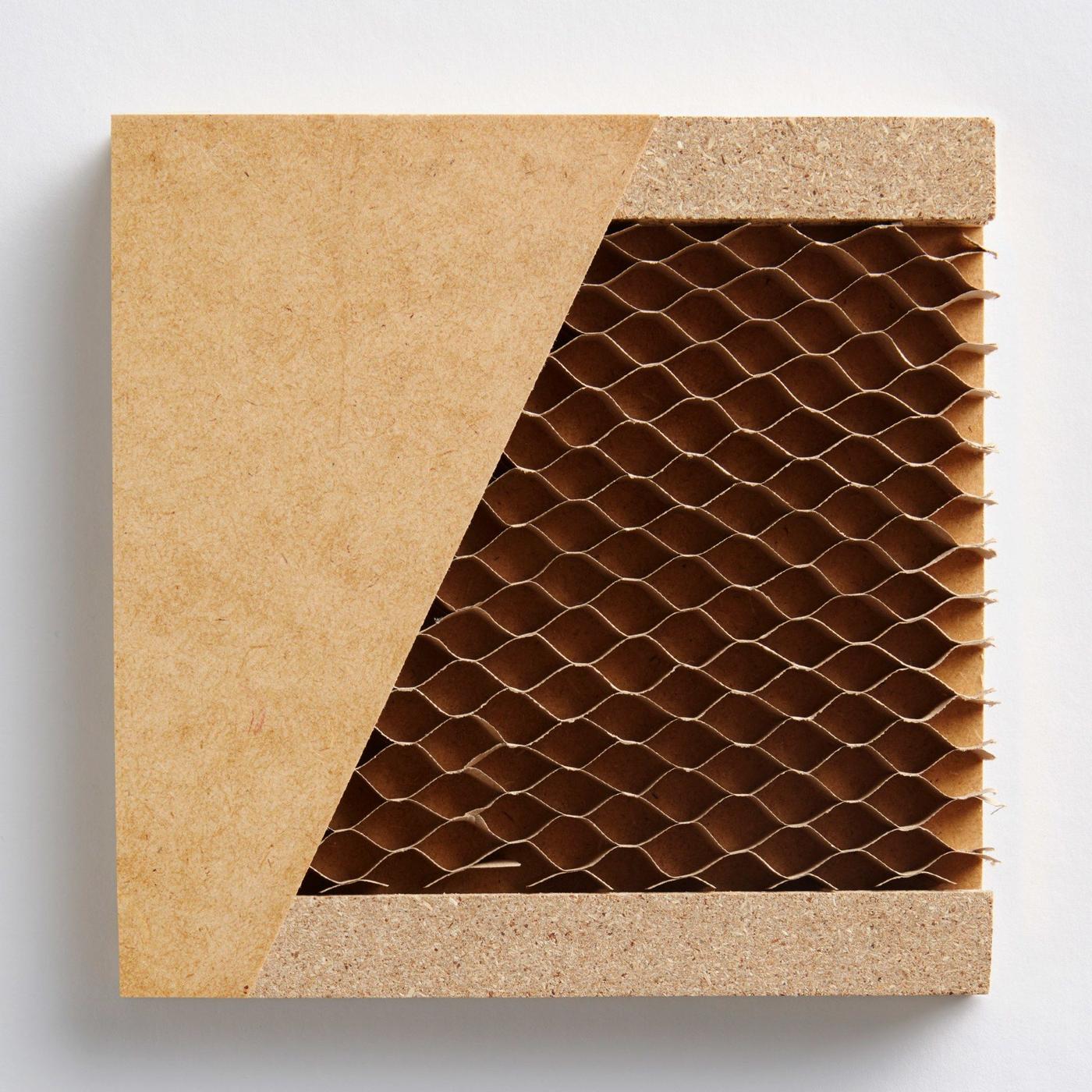 A cross section of a furniture panel showing an outer layer of masonite, a frame of particle board and a honeycomb core.