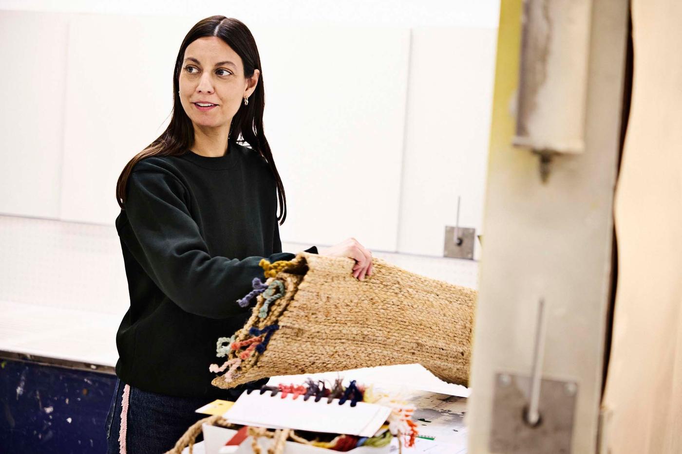 Designer Paulin Machado working on the RAKLEV rug.