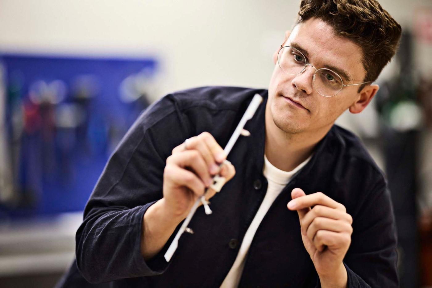 Designer Lukas Bazle looks at a lighting component.