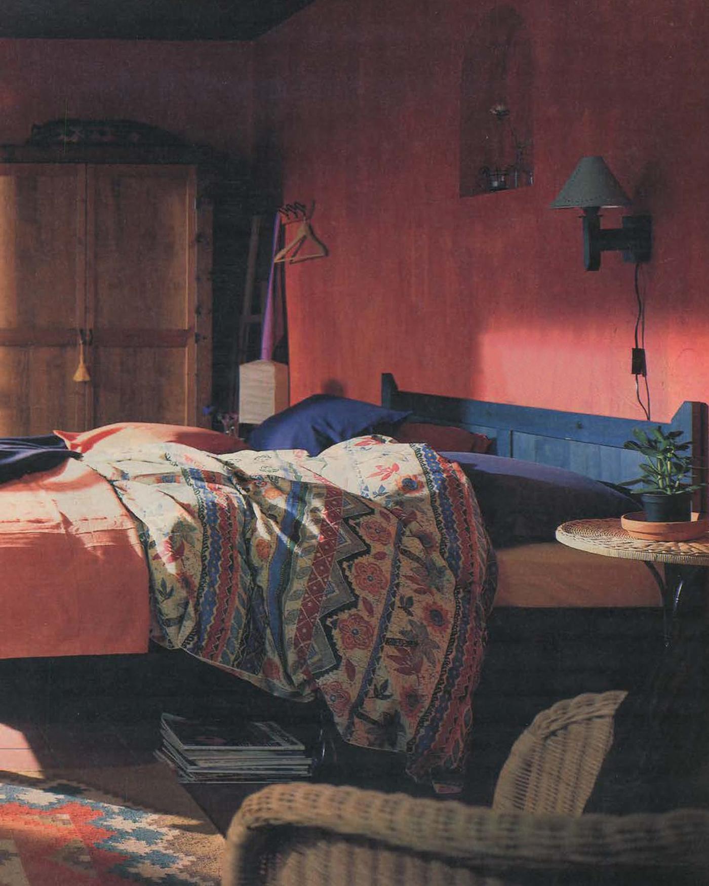 A page from the 1996 IKEA Catalogue showing a bed with a patterned duvet cover and dark blue bedlinen.