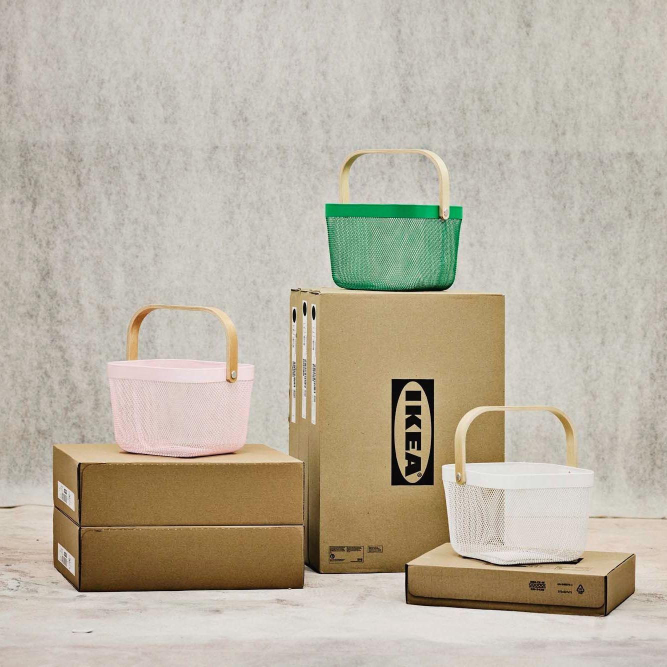 IKEA boxes form three podiums of different heights, each with a RISATORP basket on top.