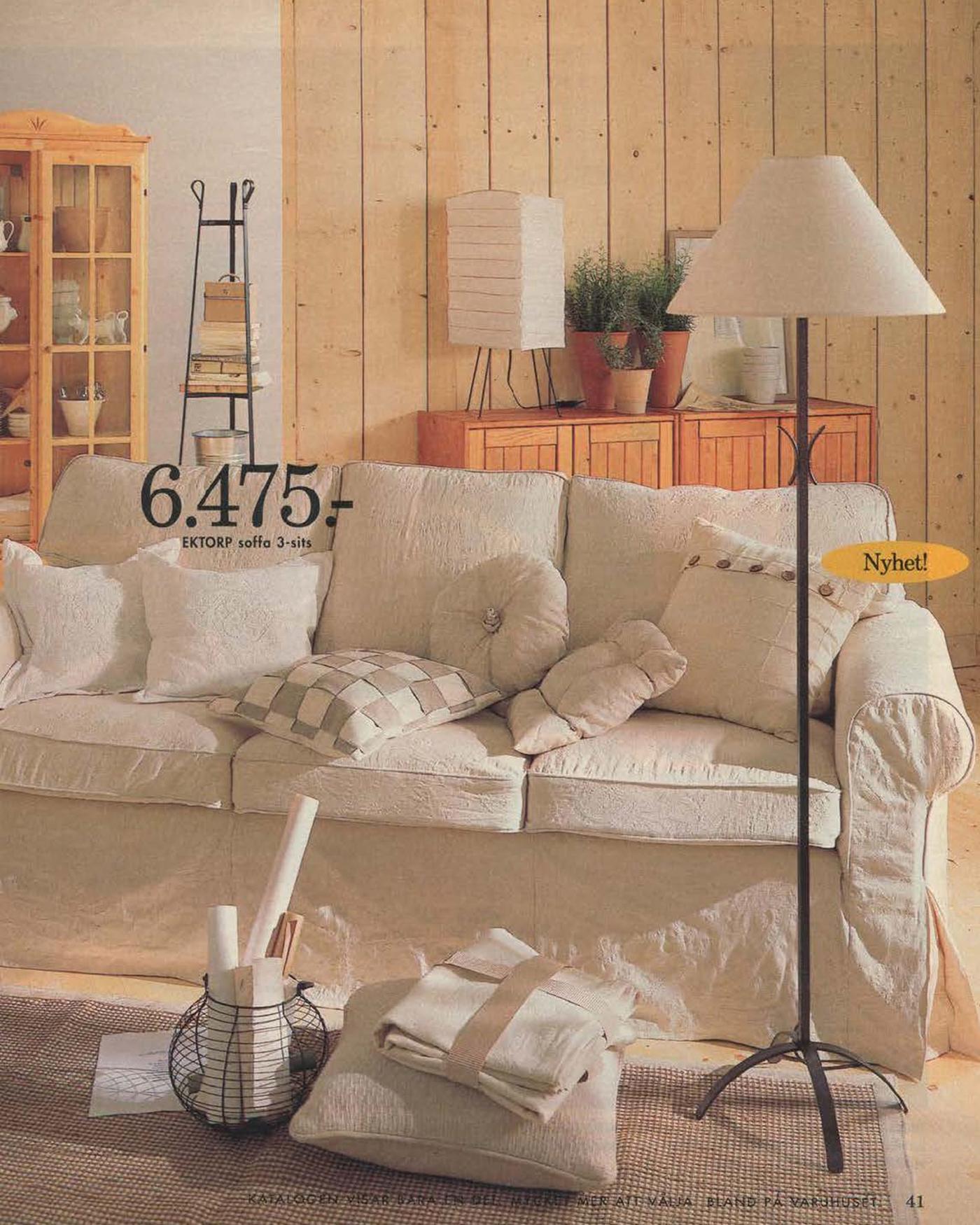 A page from the 1996 IKEA Catalogue featuring a cream sofa with a removable cover with a pleated skirt, in a light wood panelled living room.