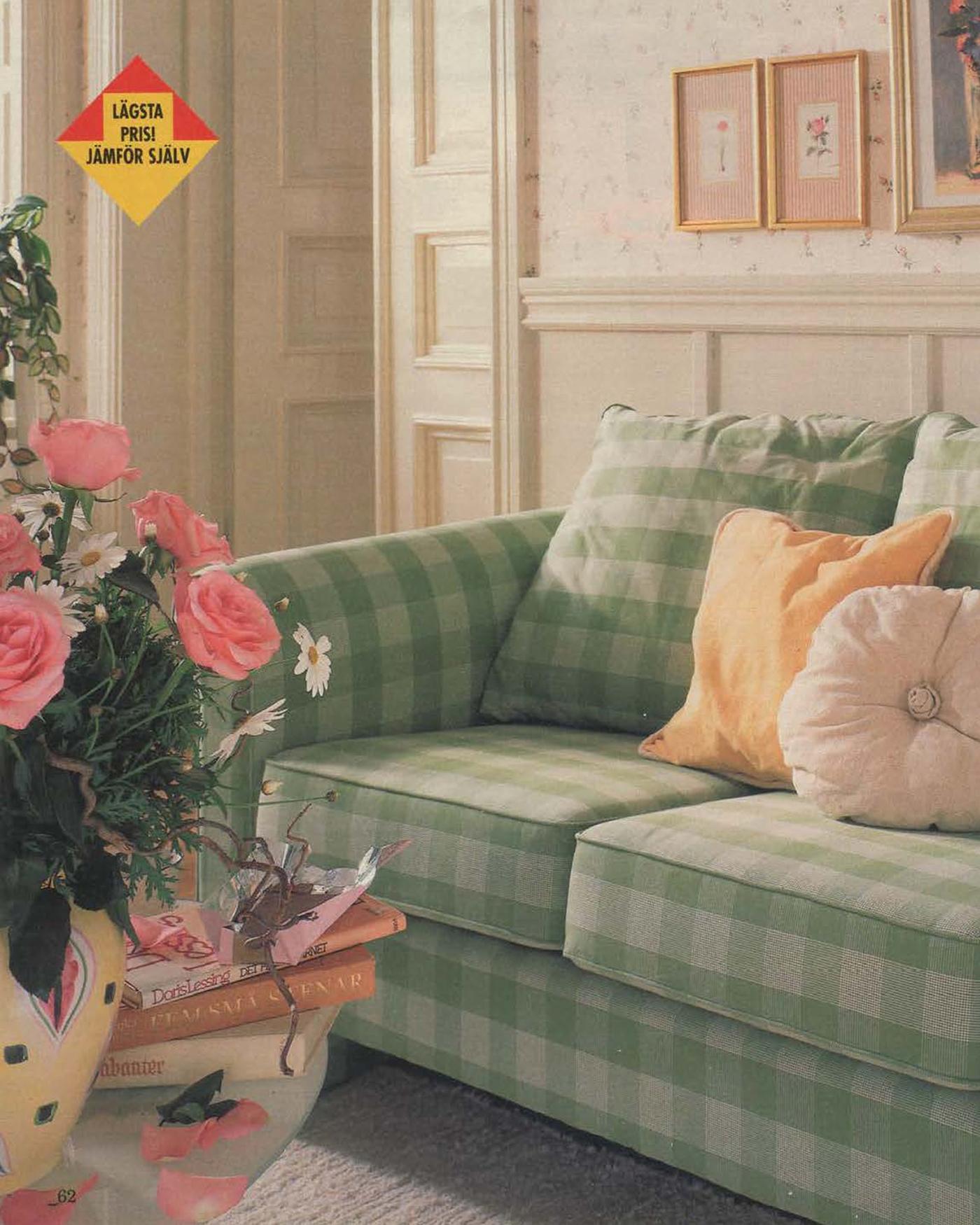 A green check sofa in a traditional style living room, with pink flowers in a vase, from 1996.
