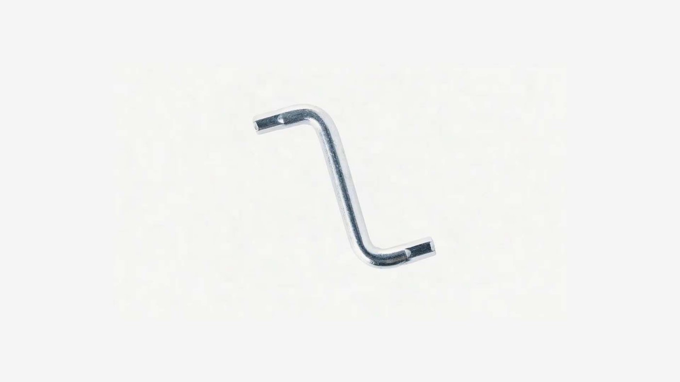 An Allen key rotating in the air in a light grey environment.