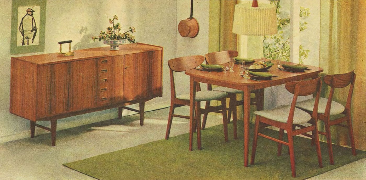 A sunny dining area room set from 1965 with green rug under the table, green curtains, green wall art and green table settings.