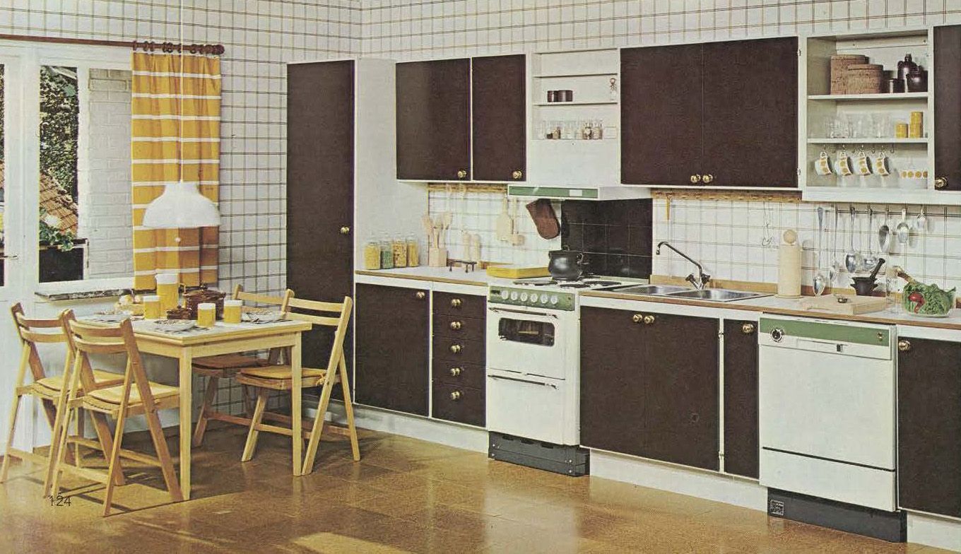 A kitchen from the 1973 IKEA catalogue featuring black and white units and yellow curtains.