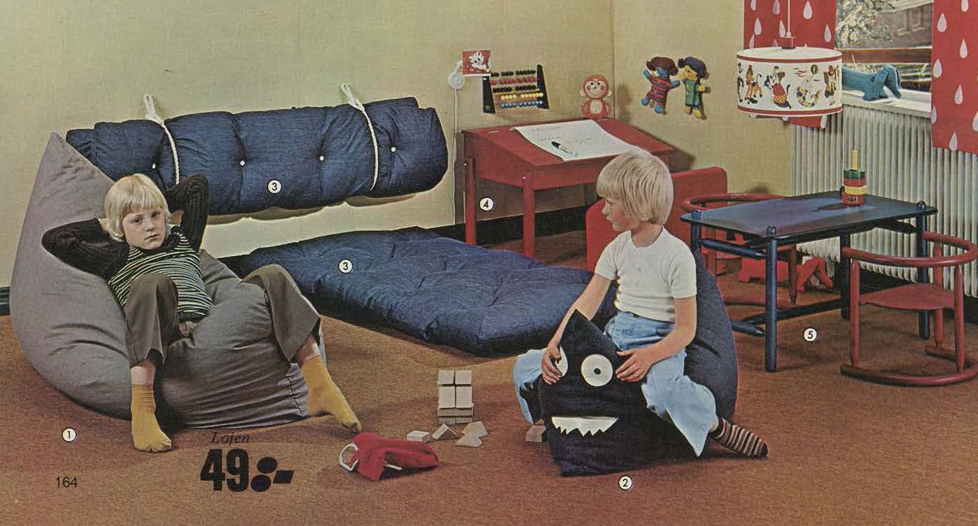 Two children lounge in their play room.