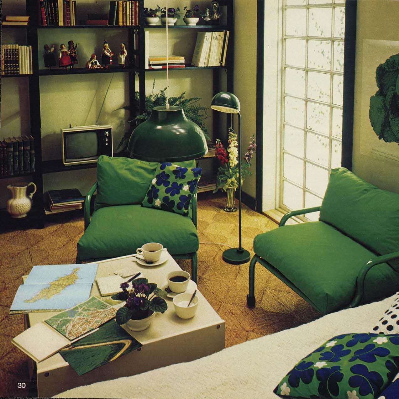Blue shelves in a green living room.