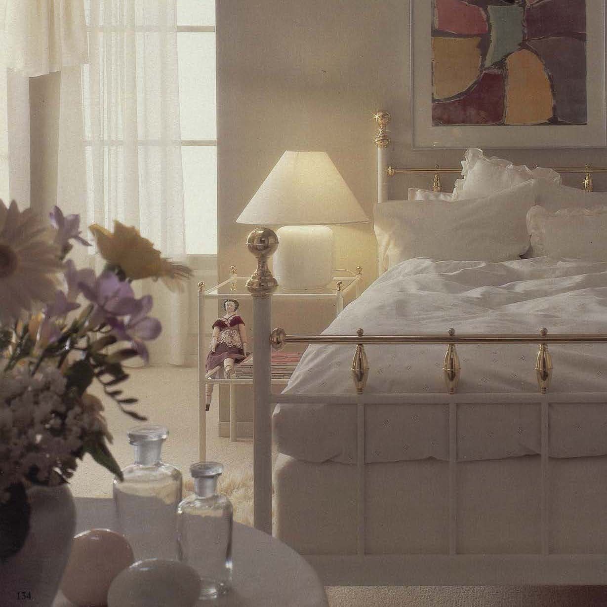 The 1985 IKEA catalogue showing a romantic white bedroom with flowers and a metal framed bed.