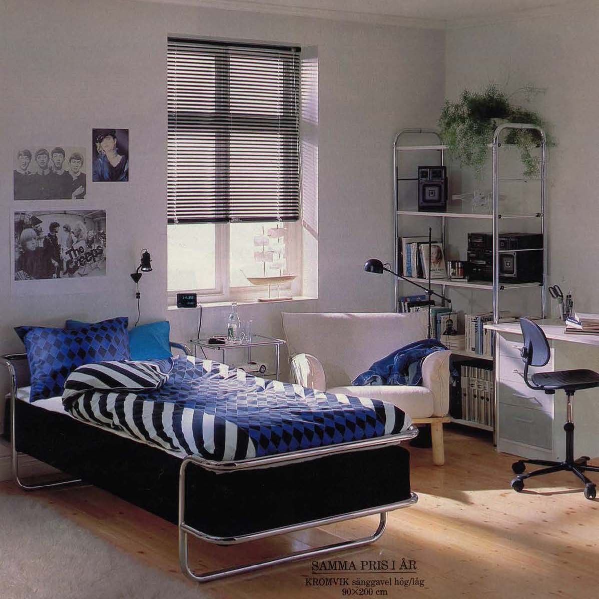 The 1988 IKEA catalogue showing a metal bed in a white bedroom. The bed has a striped duvet cover. There are posters on the wall. 
