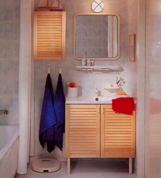 A small bathroom with pine cupboard fronts.