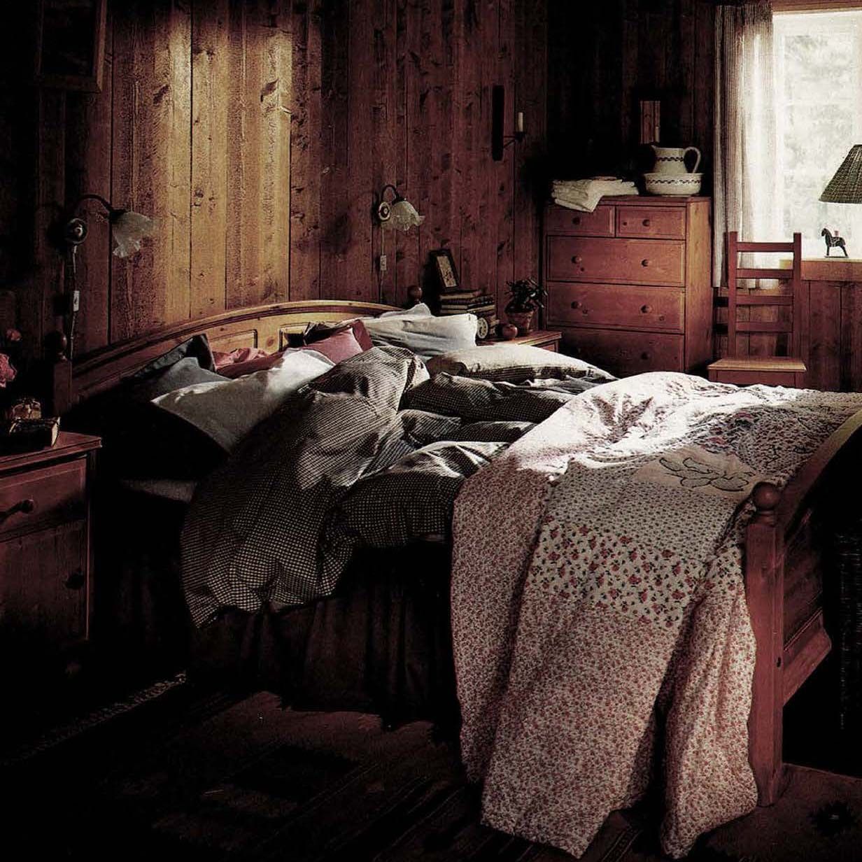 The 1995 IKEA catalogue showing a rustic wood bedroom with a messy bed.