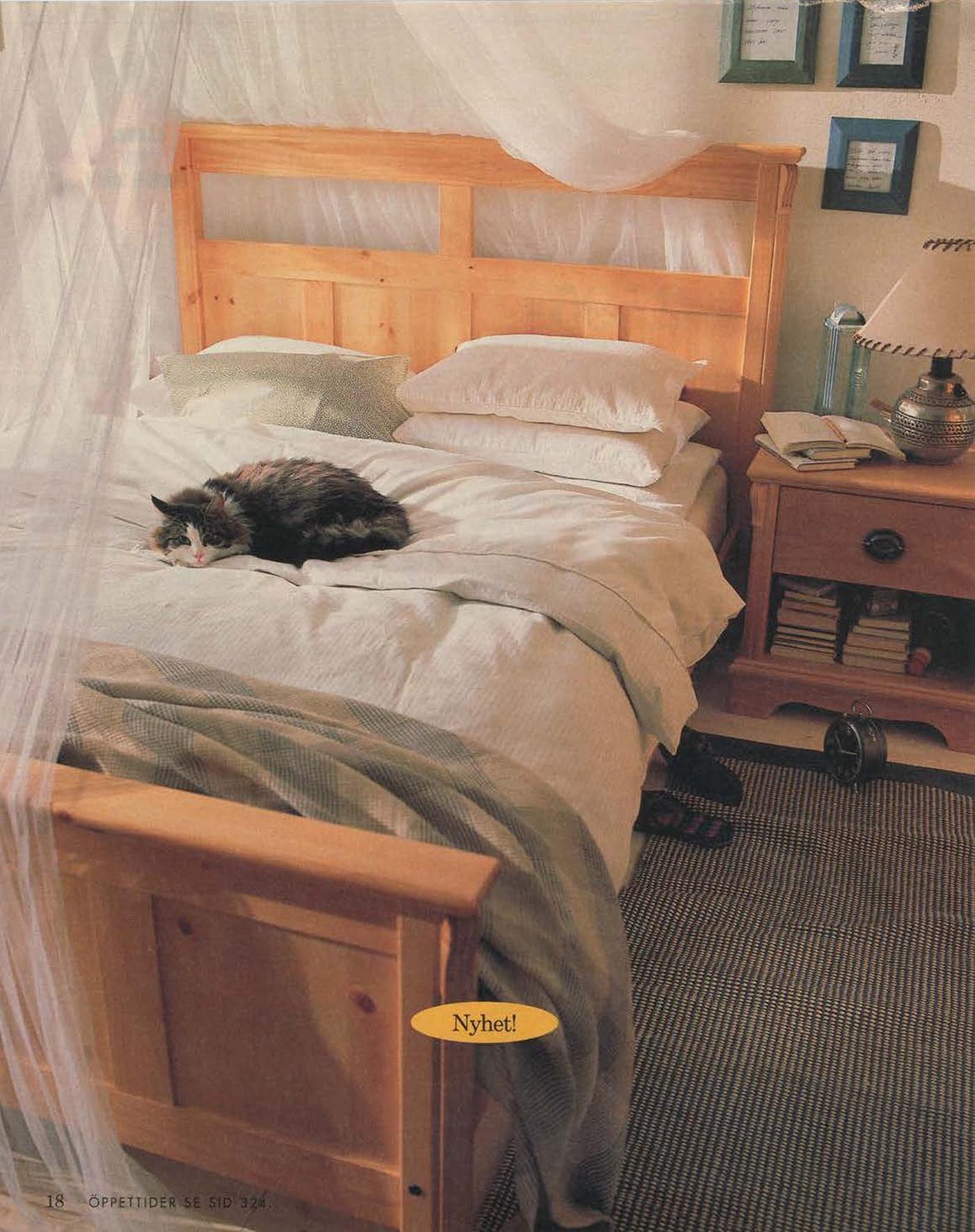 A bedroom roomset from 1996 showing a cat laying on a wooden bed. The bed has gauze-like curtains draped above.