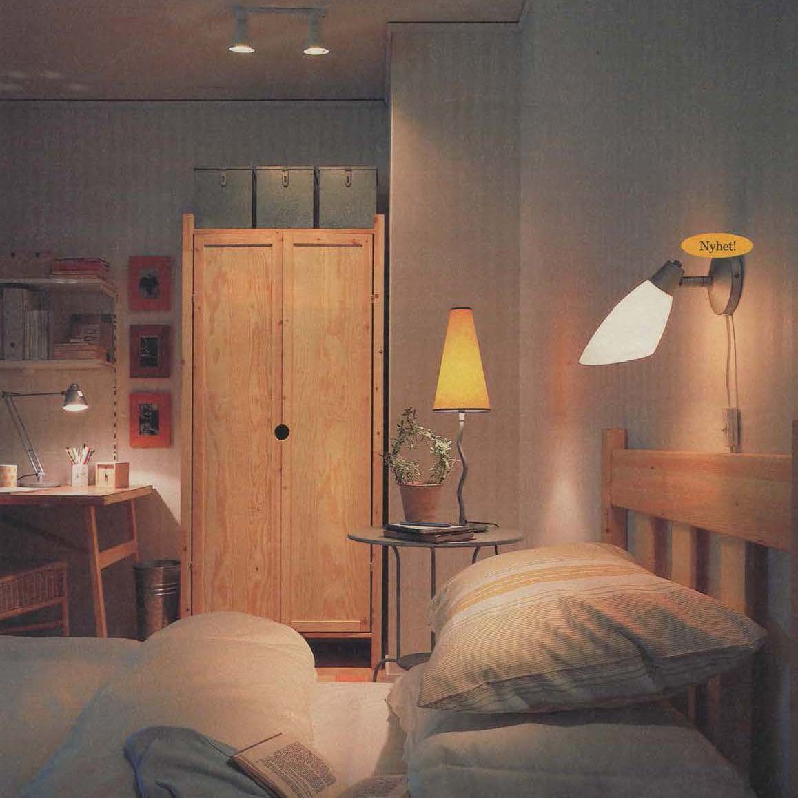 The 1996 IKEA catalogue showing a bedroom with a wardrobe and desk in the background and a bed with a light above in the foreground.