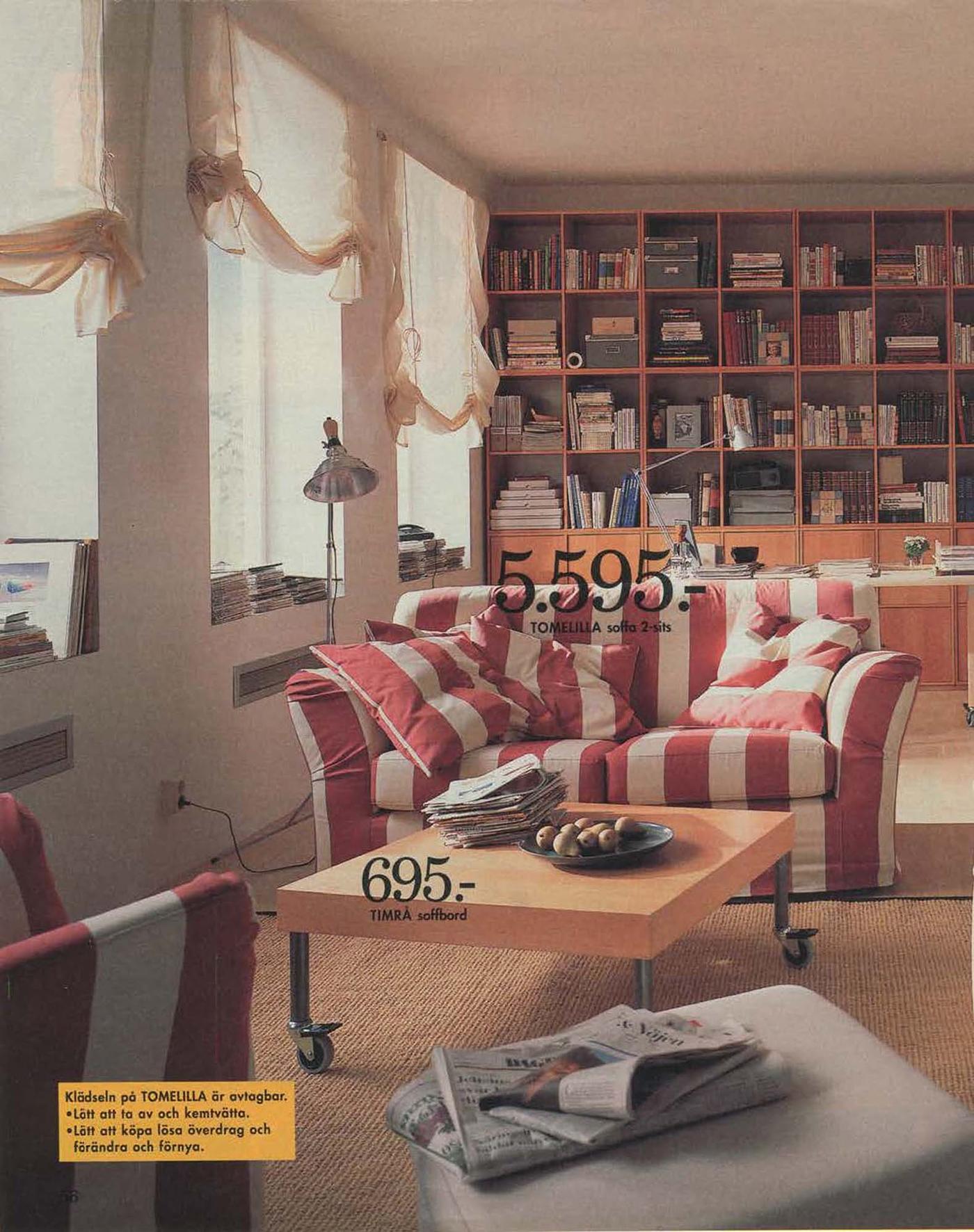 A living room from the 1996 catalogue, with a striped sofa and yellow swag net curtains at the windows.
