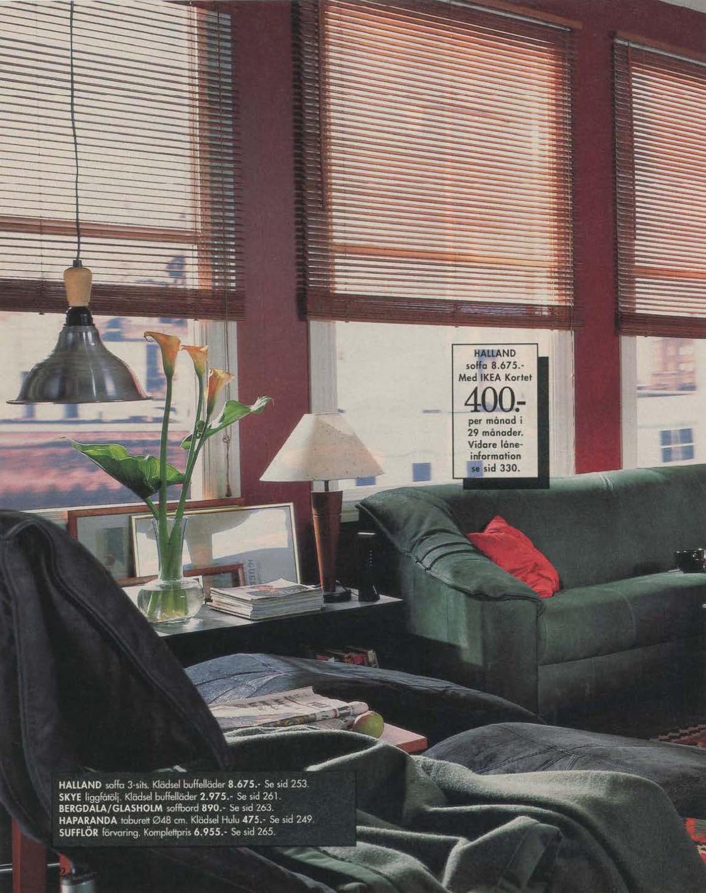 A metropolitan style living room setting from 1996, showing a green sofa and bamboo blinds at the large windows.